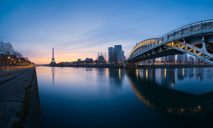 Paris skyline with Eiffel Tower and bridge at dusk