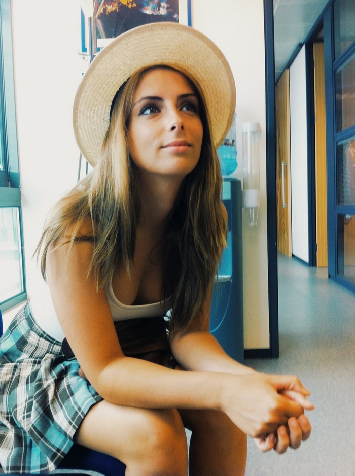 Woman wearing a hat and plaid skirt