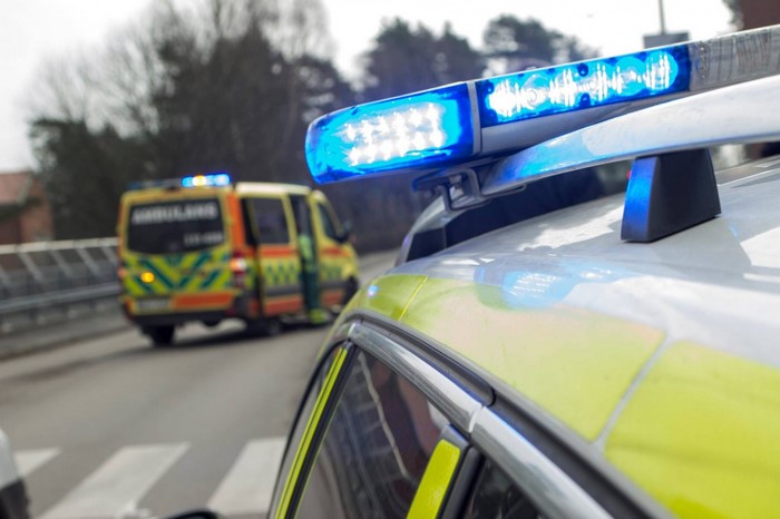 Police car with blue lights and ambulance