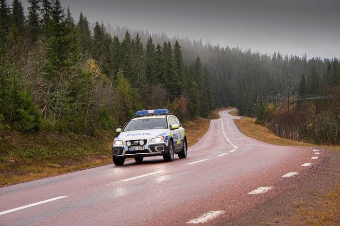 Swedish Police Volvo XC70 driving on a winding road
