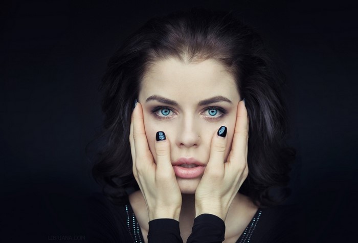 Portrait of Woman with Blue Eyes and Black Hair