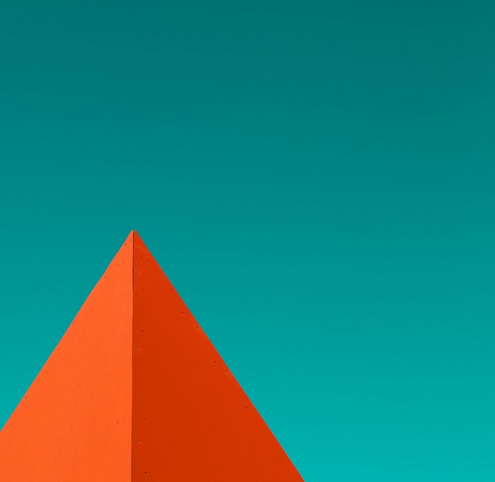 Orange pyramid against a teal sky