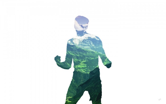 Silhouette of a man with a mountain landscape overlay
