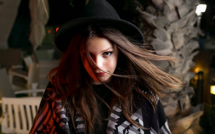 Woman wearing a witch hat and poncho