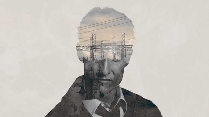Double exposure of a man's head with power lines and factories