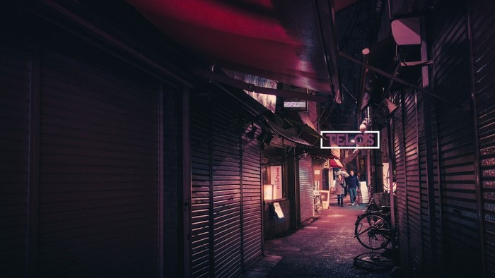 Telos sign in a dark alley at night