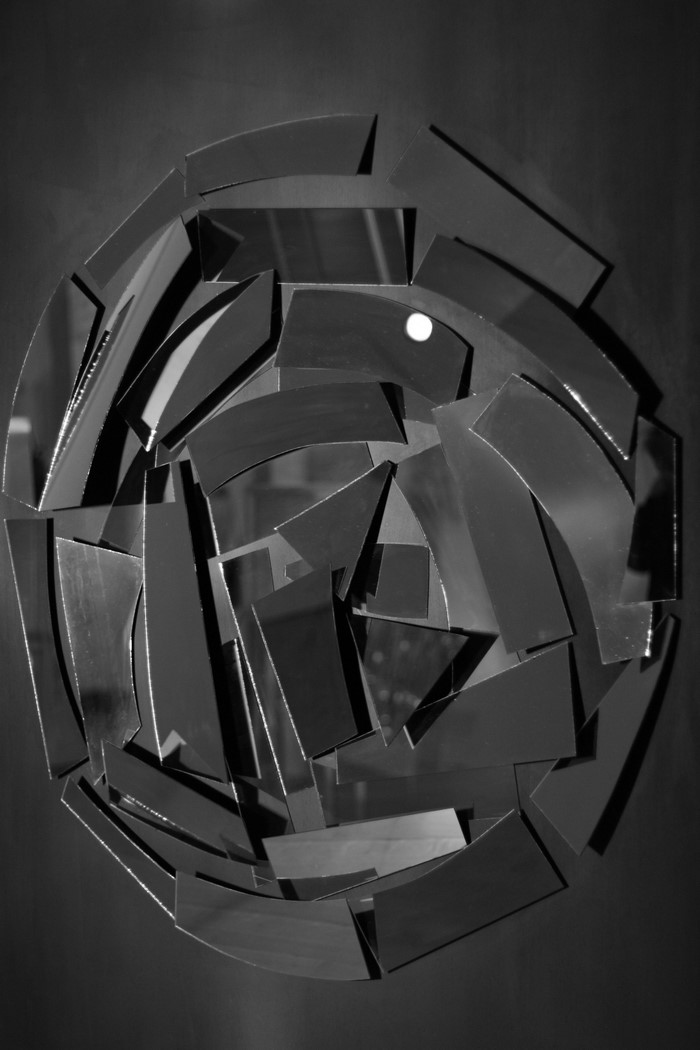 Abstract mosaic of broken mirrors with a bright light