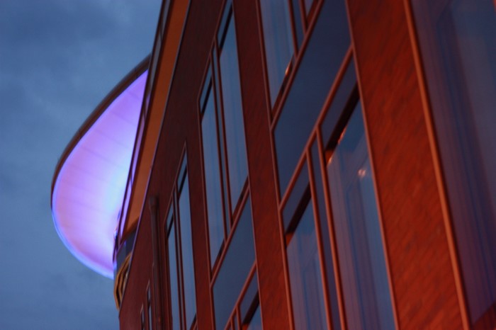 Modern building with purple lighting at dusk
