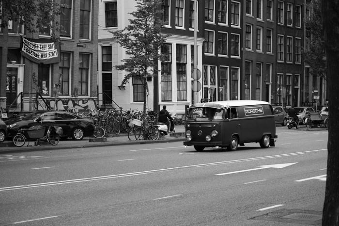 Volkswagen van with Porsche logo on street