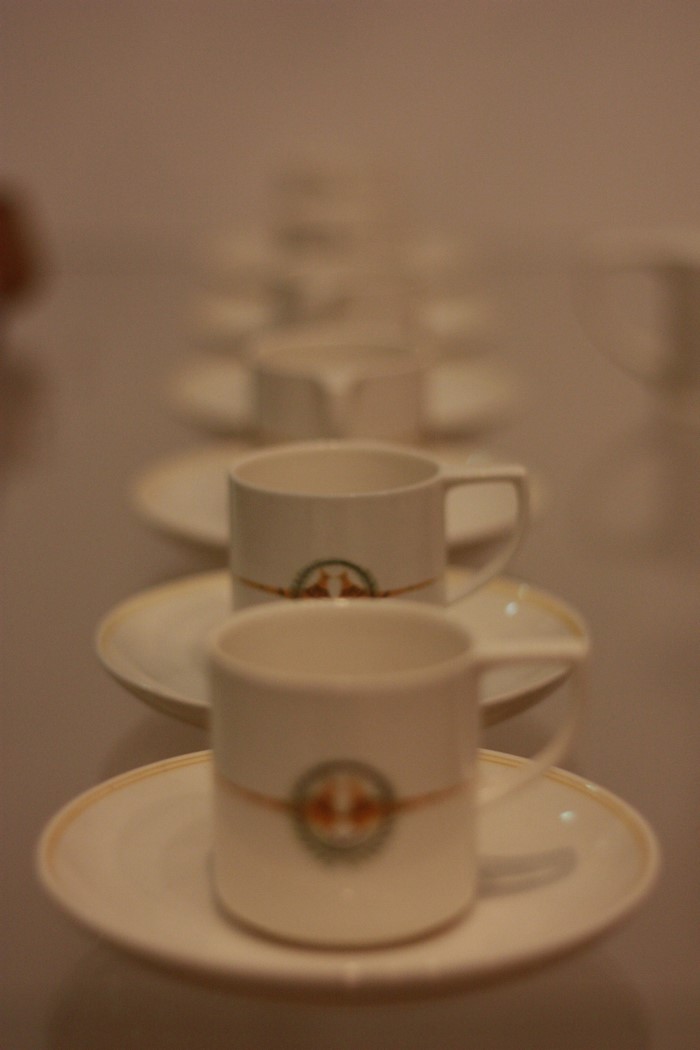 Row of coffee cups and saucers
