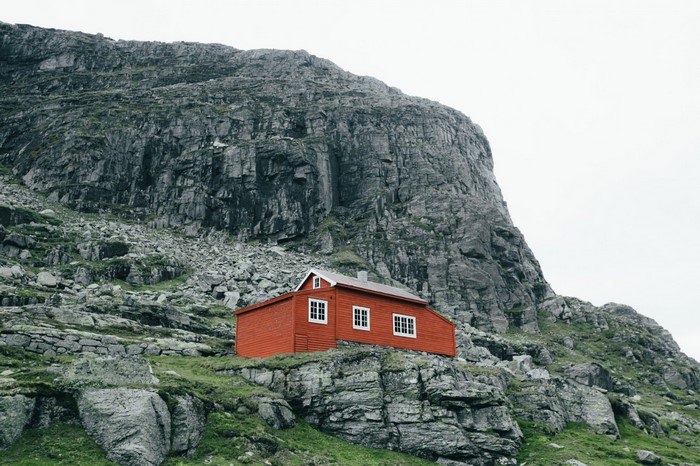 Red house on a rocky mountain slope