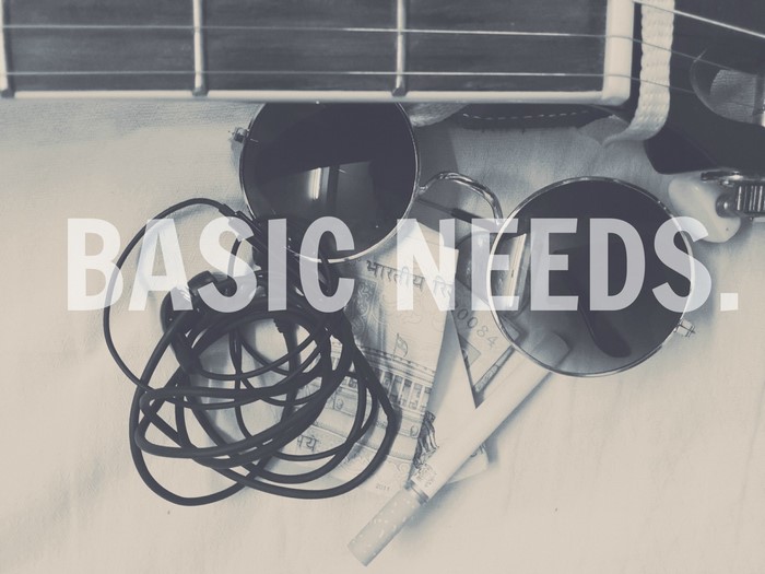 Basic Needs text over guitar, sunglasses, money, and cigarette