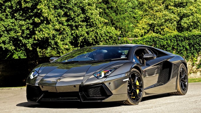 Gray Lamborghini Aventador parked on a road
