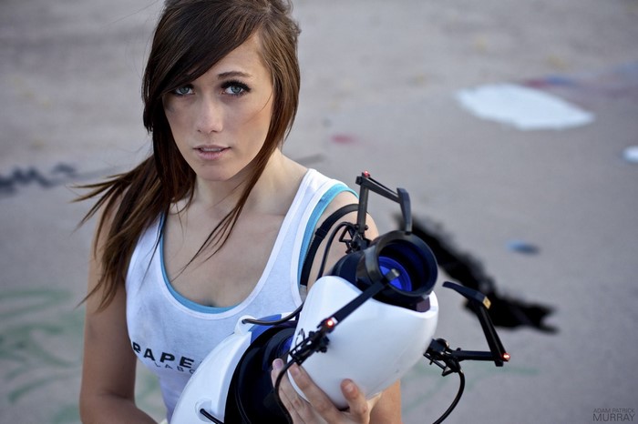 Cosplayer holding a Portal Gun from Aperture Laboratories