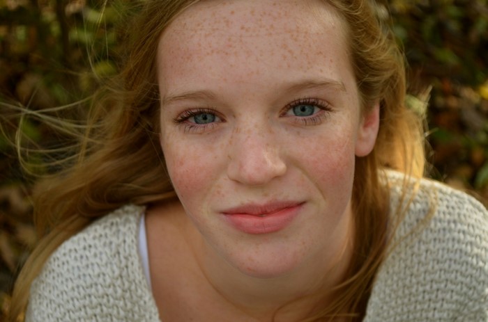 Close up portrait of a young woman with freckles