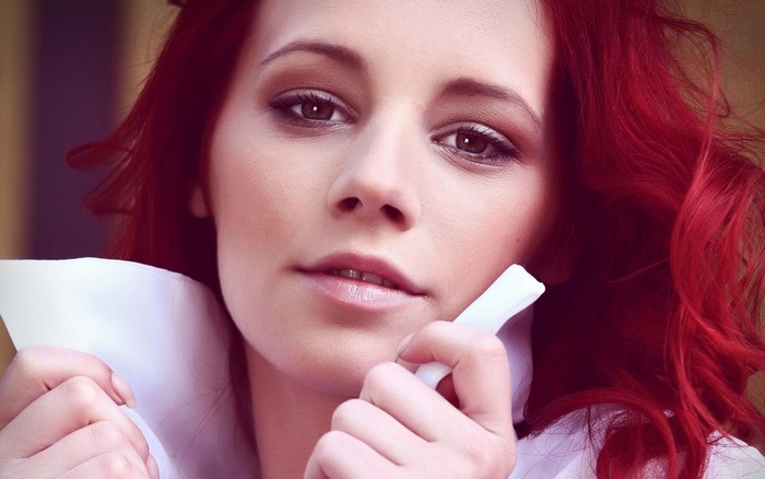 Close-up Portrait of a Redhead Woman with Intense Gaze