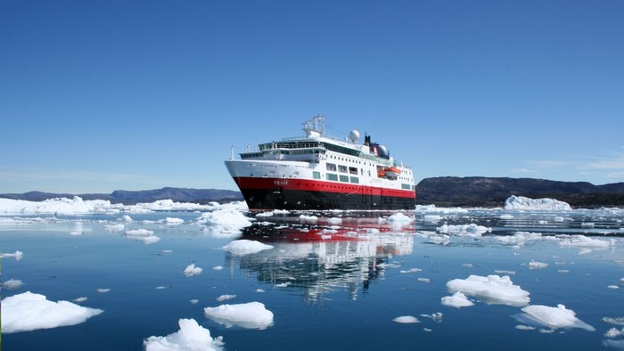 Ship sailing through icebergs in Greenland