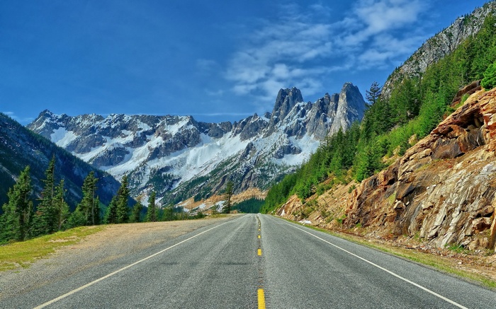 Scenic mountain road with snow-capped peaks