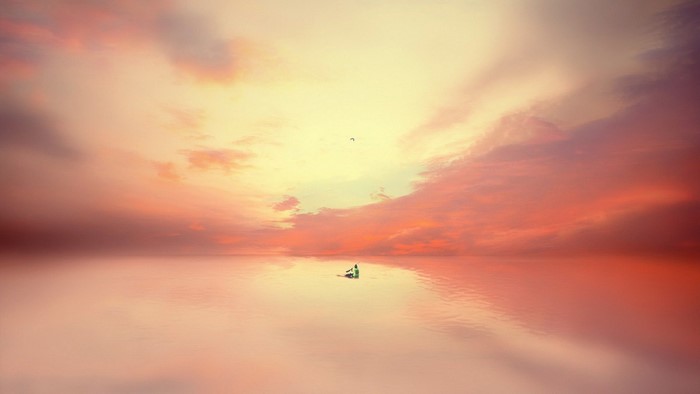 Sailboat on a calm sea at sunset
