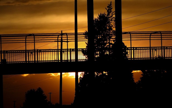 Silhouette of a bridge against a sunset sky