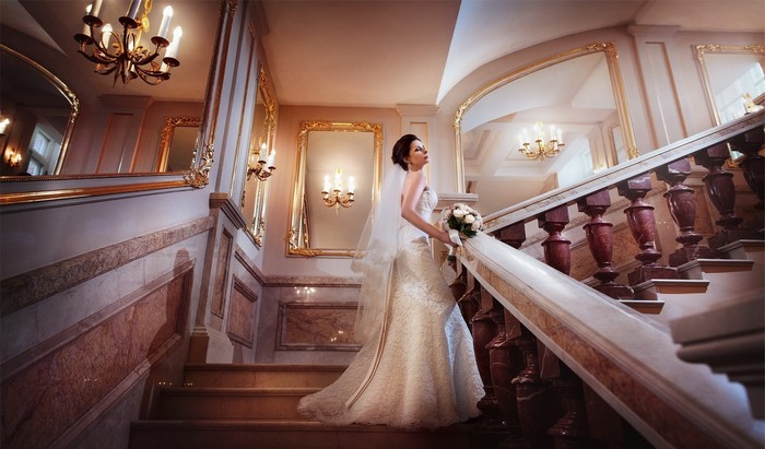 Bride in a wedding dress on a grand staircase