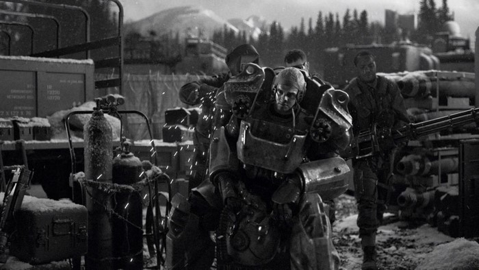 Soldiers in power armor with heavy weapons in a snowy environment