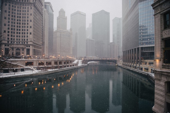 Chicago River in winter with skyscrapers and snow