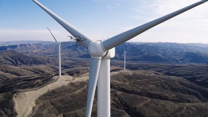 Drone inspecting a wind turbine