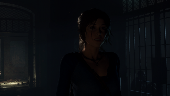 Lara Croft from Rise of the Tomb Raider in a dark prison