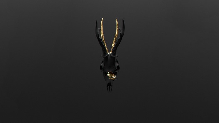 Black deer skull with gold antlers and leaf