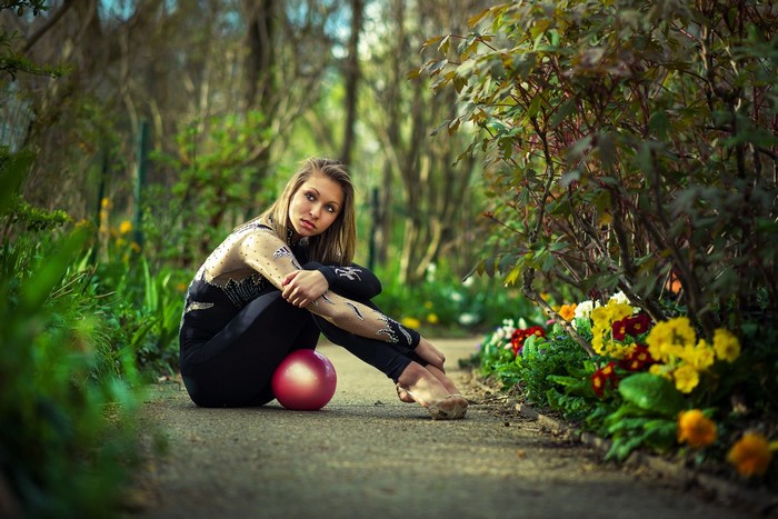 Gymnast with ball in a garden