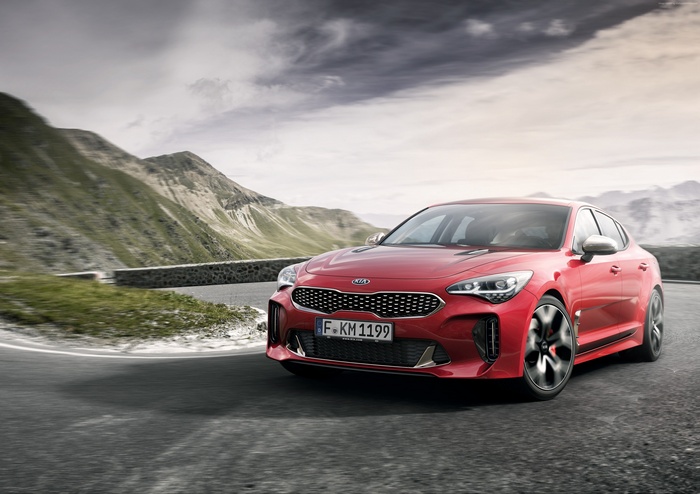 Red Kia Stinger GT on a mountain road