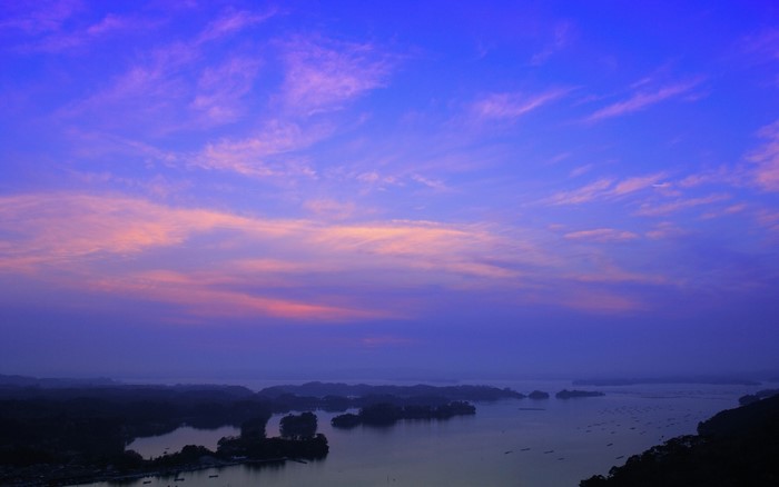 Sunset over a bay with islands and clouds