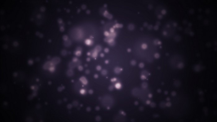 Abstract purple bokeh lights in darkness