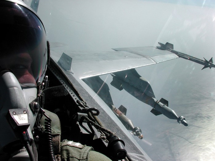 Pilot in F/A-18 Hornet with bombs and missile