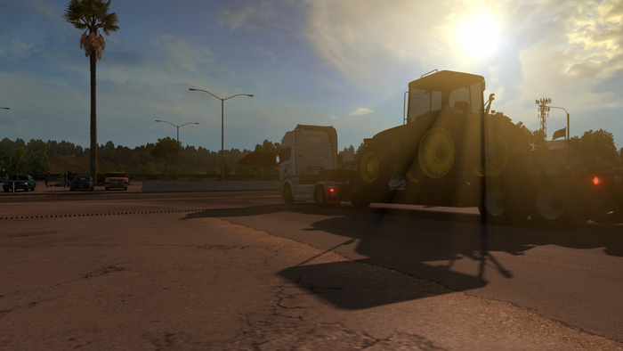 Tractor trailer truck carrying a tractor in American Truck Simulator