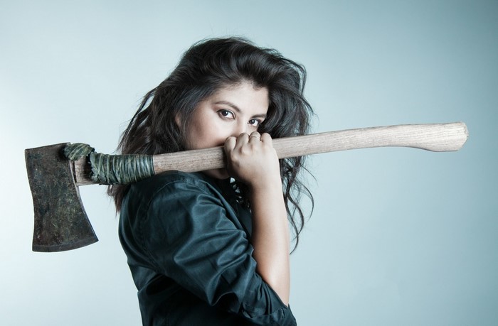 Woman holding an axe over her shoulder