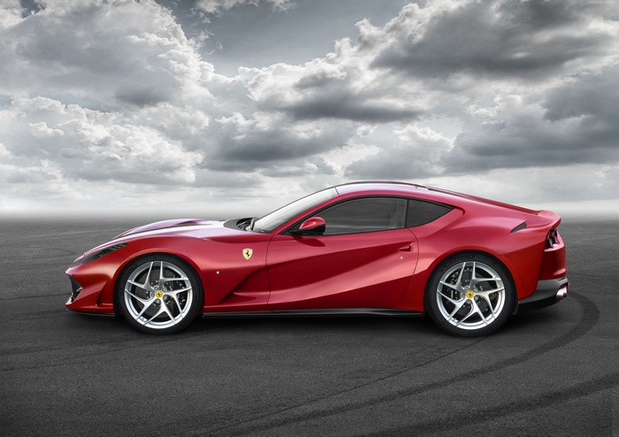 Red Ferrari 812 Superfast parked on asphalt