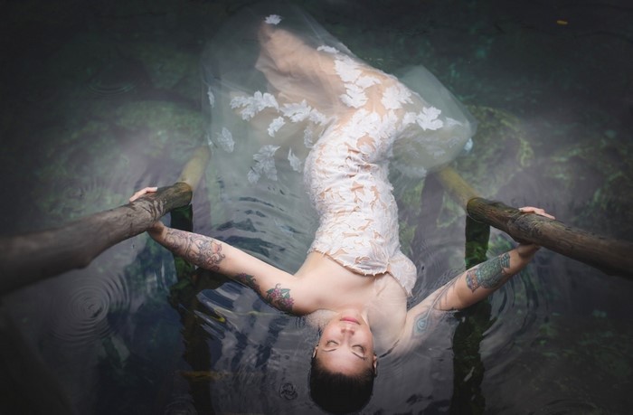 Woman in a white dress floating in water