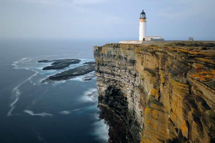 Lighthouse on a cliff overlooking the sea