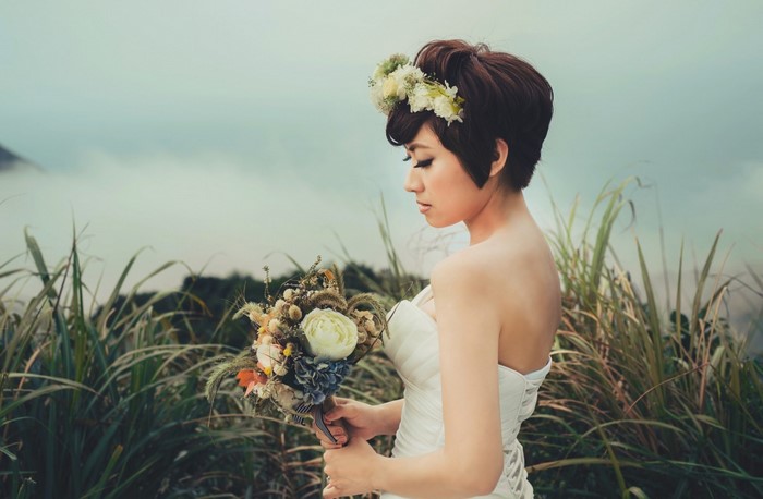 Bride with flower crown and bouquet outdoors