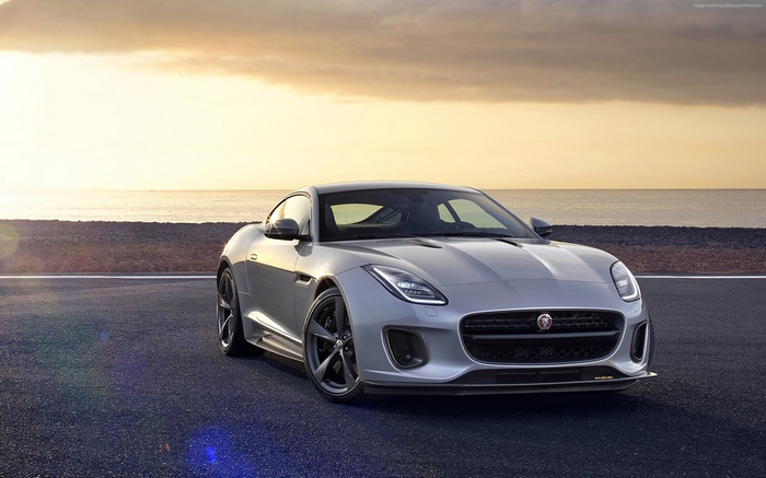 Silver Jaguar F-TYPE Coupe on a road by the sea