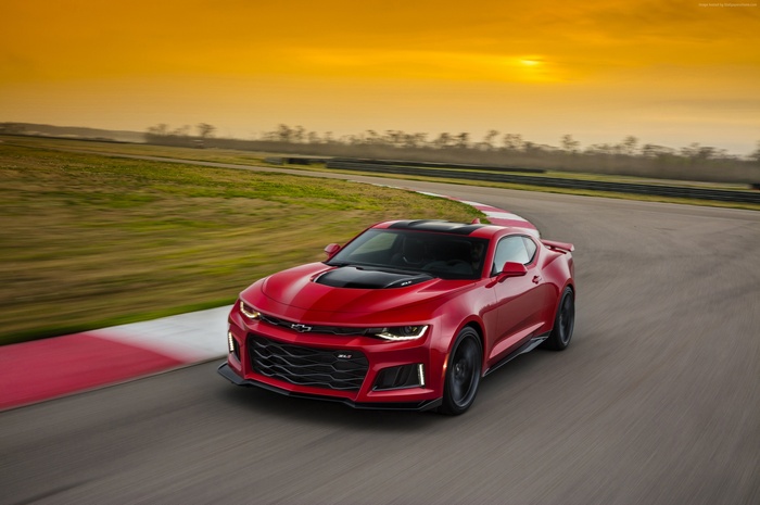 Red Chevrolet Camaro ZL1 on a race track