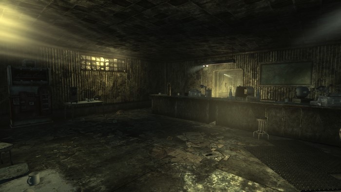 Interior of a dimly lit, dilapidated building with a bar