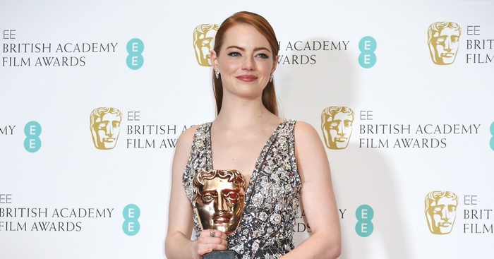 Emma Stone holding BAFTA award
