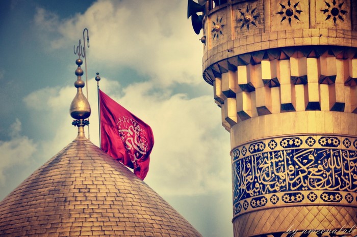 Golden dome and minaret with red flag