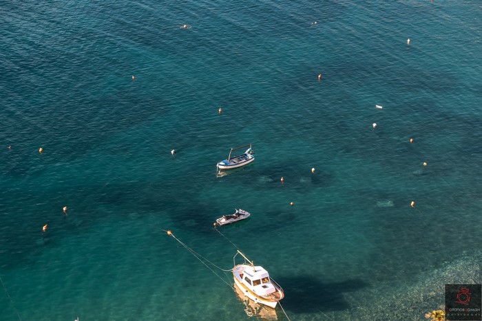 Boats and buoys in clear turquoise water