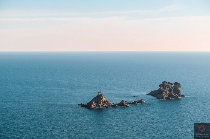 Two rocky islands in the sea with trees