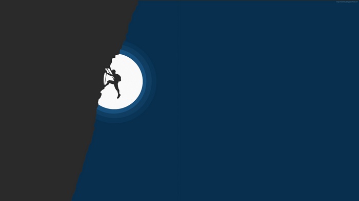 Climber on a dark mountain with a large moon
