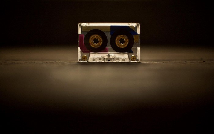 Close-up of a clear cassette tape with colorful inserts